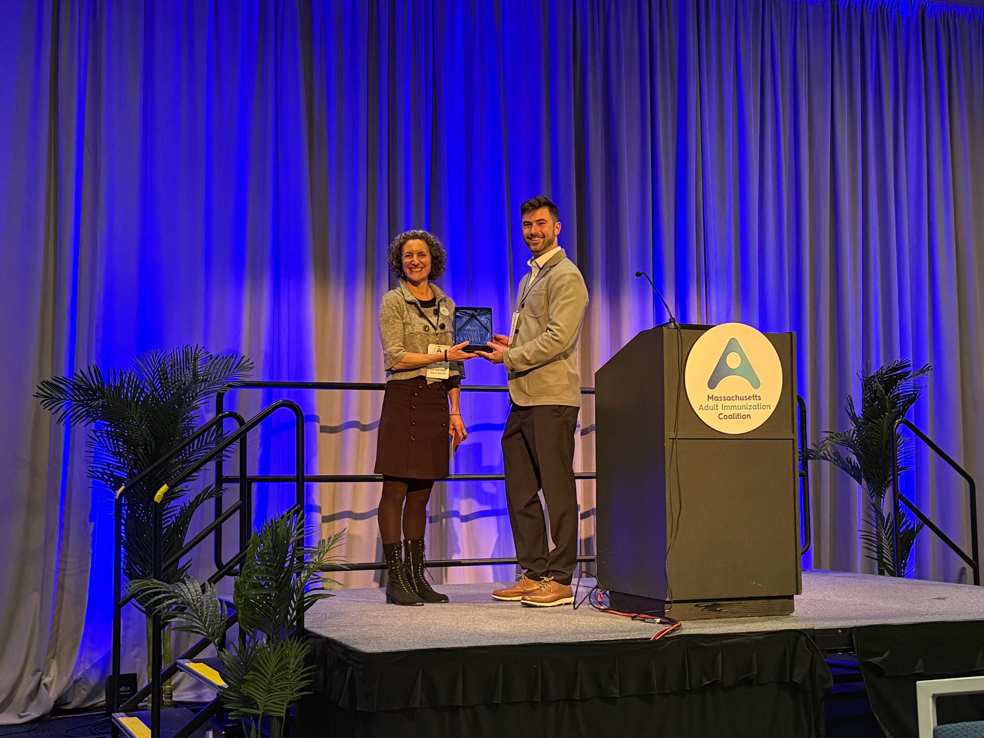 Kiko Malin, Public Health Director of the city of Amherst, MA, accepts the Massachusetts Adult Immunization Champion award on behalf of the 2026 awardee, Valley Vax.